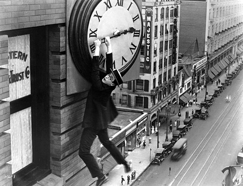 Harold Lloyd in famous scene hanging from the big hand of a clock high above Broadway